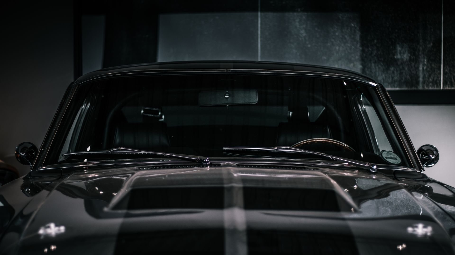 Vintage black car interior with windshield and chrome details