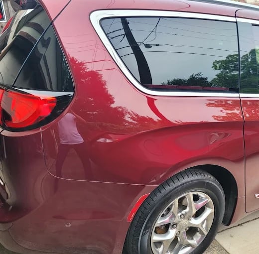 Shiny red Chrysler Pacifica minivan with glossy paint and alloy wheels